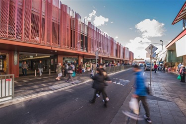 People crossing the road outside Dutton Plaza