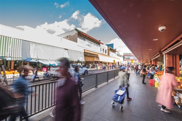 Busy sidewalk outside Dutton Plaza