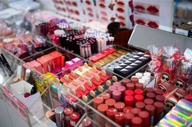 Closeup of lipsticks and other small beauty products sold at Beauty Mart in Dutton Plaza