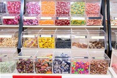 Self service food containers at Jerky House in Dutton Plaza featuring various types of colourful confectionery