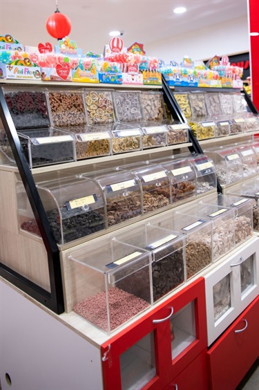 Self service food containers at Jerky House in Dutton Plaza featuring various types of snack food