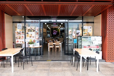 Outdoor seating and entrance to Lucky Cat Vietnamese Restaurant at Dutton Plaza