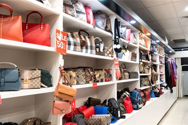Shelf space featuring a wide range of handbags and purses at Niko Fashion in Dutton Plaza
