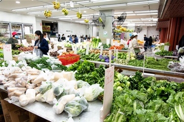 Shop aisles filled with fruit and vegetables inside Number One Fruit Shop at Dutton Plaza