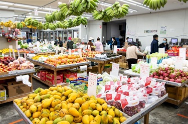 Shop aisles filled with fruit and vegetables inside Number One Fruit Shop at Dutton Plaza