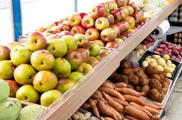 Supermarket shelves full of various fruit and vegetables like potatoes, sweet potatoes and apples at Sanfa Supermarket in Dutton Plaza