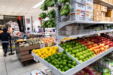 View from inside Sanfa supermarket at Dutton Plaza with various fruit visible on the shelves
