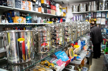 Shelf space at Senselected Trading in Dutton Plaza displaying kitchen items such as stackable cookware and disposable cloths