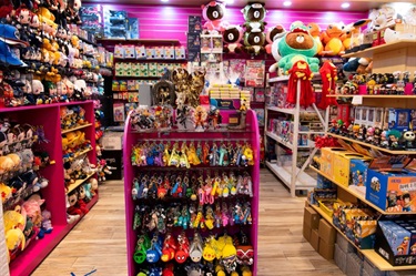 Shelf space at Sydney Morning Glory displaying range of merchandise from colourful fictional character-based brands like Sailor Moon, Pokemon, Avengers and One Piece