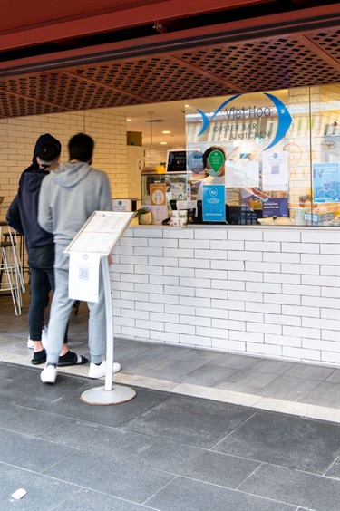 People queuing outside Viet Hoa Oyster Bar at Dutton Plaza