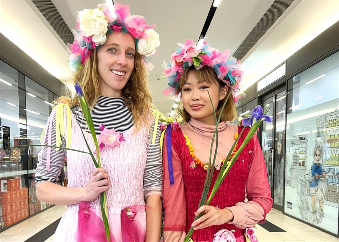 Girls dressed up as fairies with flowers 